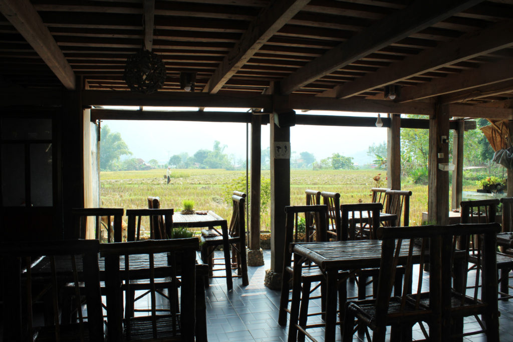 View of rice paddy fields from the cafe at The manmade "stream" at Mai Chau Countryside Homestay