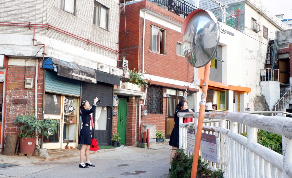 Korean students hang around taking photos at Ihwa Mural Village
