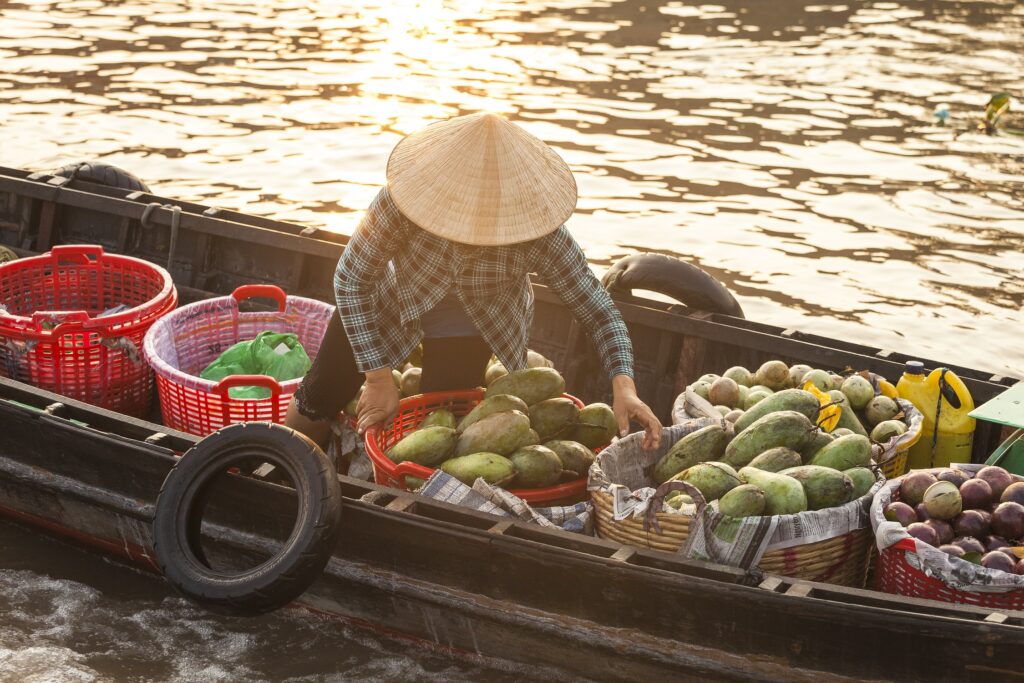 A fruit vendor at Cai Rang Floating Market Can Tho